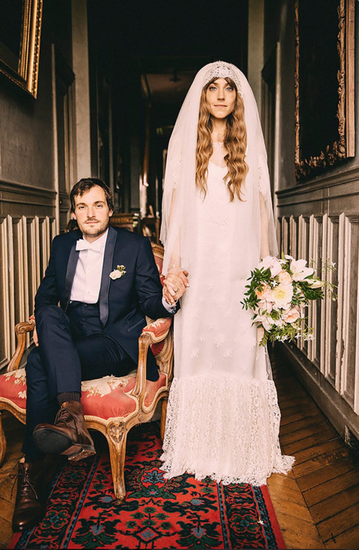 wedding themes - bride wearing an antique veil holding sitting husbands hand