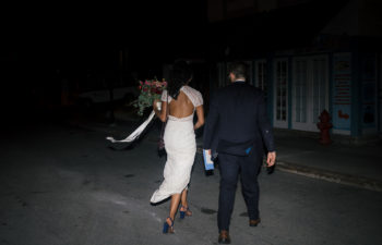 Bride and groom walking into the night