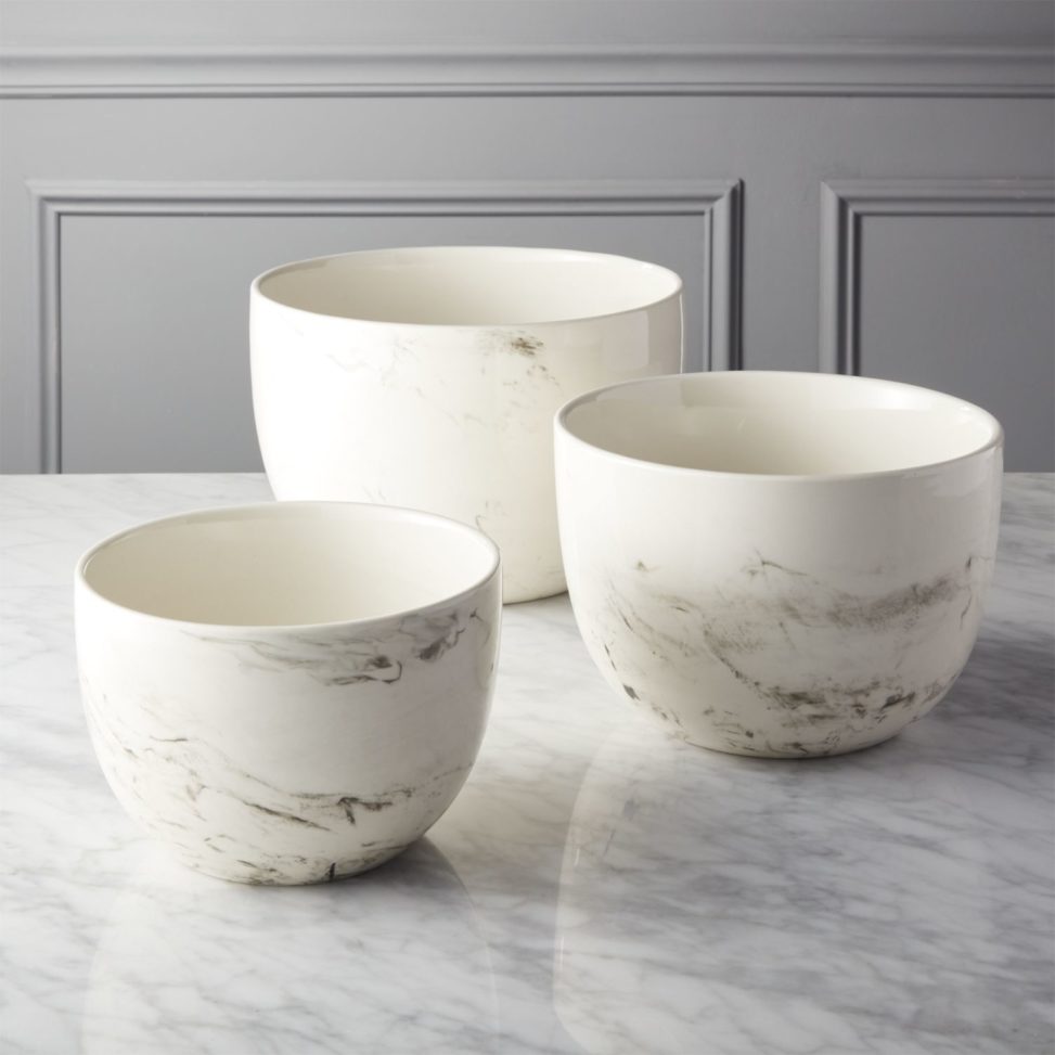 Three marble mixing bowls sitting on marble counter
