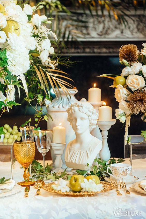 wedding themes - ancient Greece style bust on table surrounded by flowers and glassware