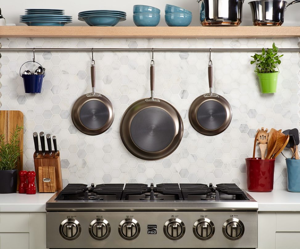 View of a set of pans hanging over a kitchen stove