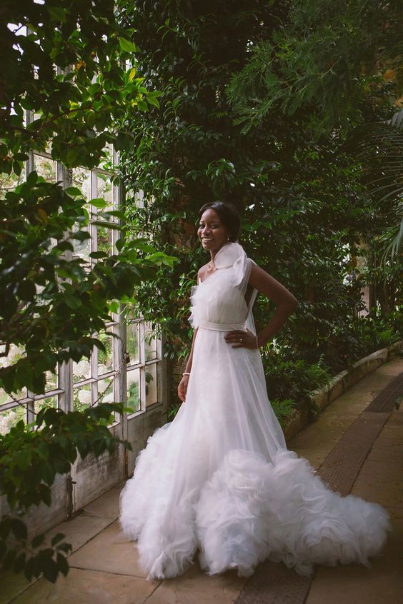 black bride wearing a frilly white dress