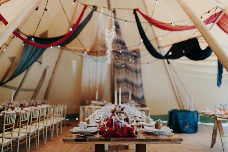 decorated tables set up inside a tent