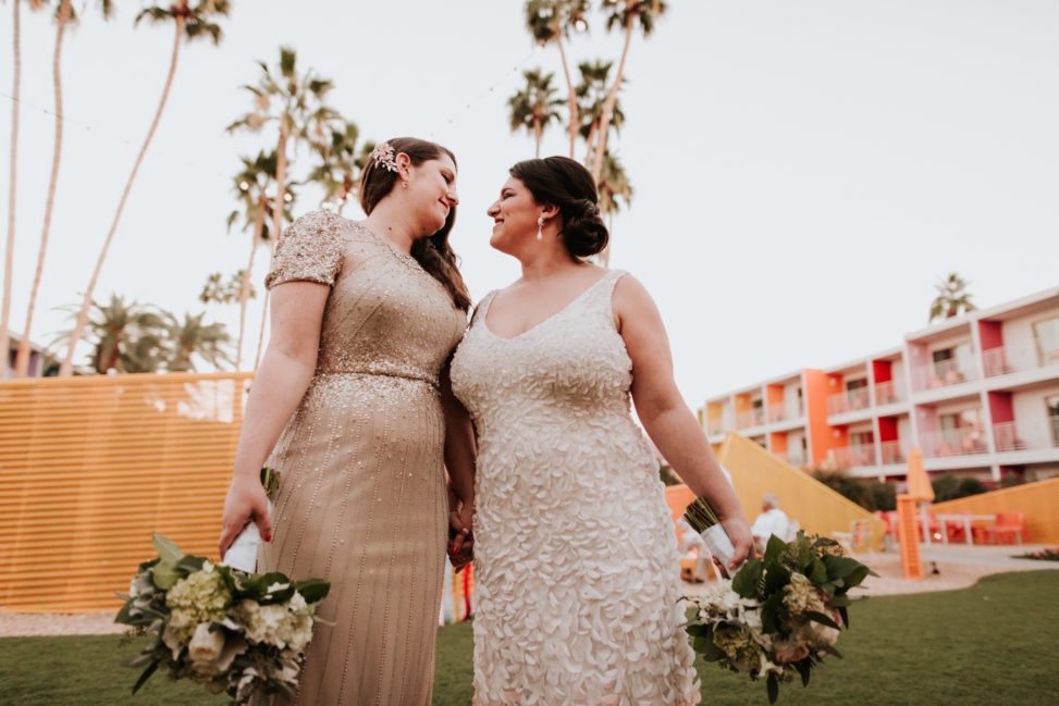 two brides in sequins holding hands at the Saguaro Hotel