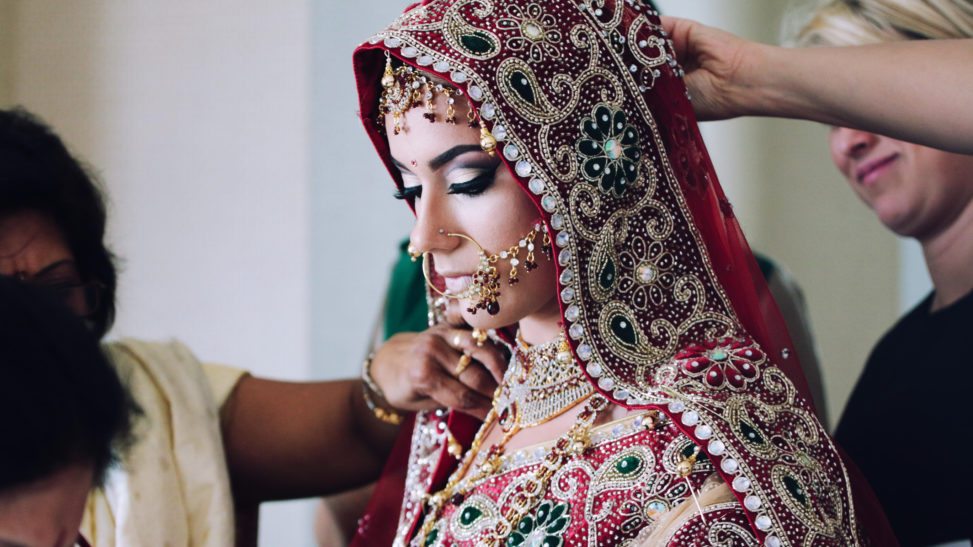 A South east Asian bride gets dressed