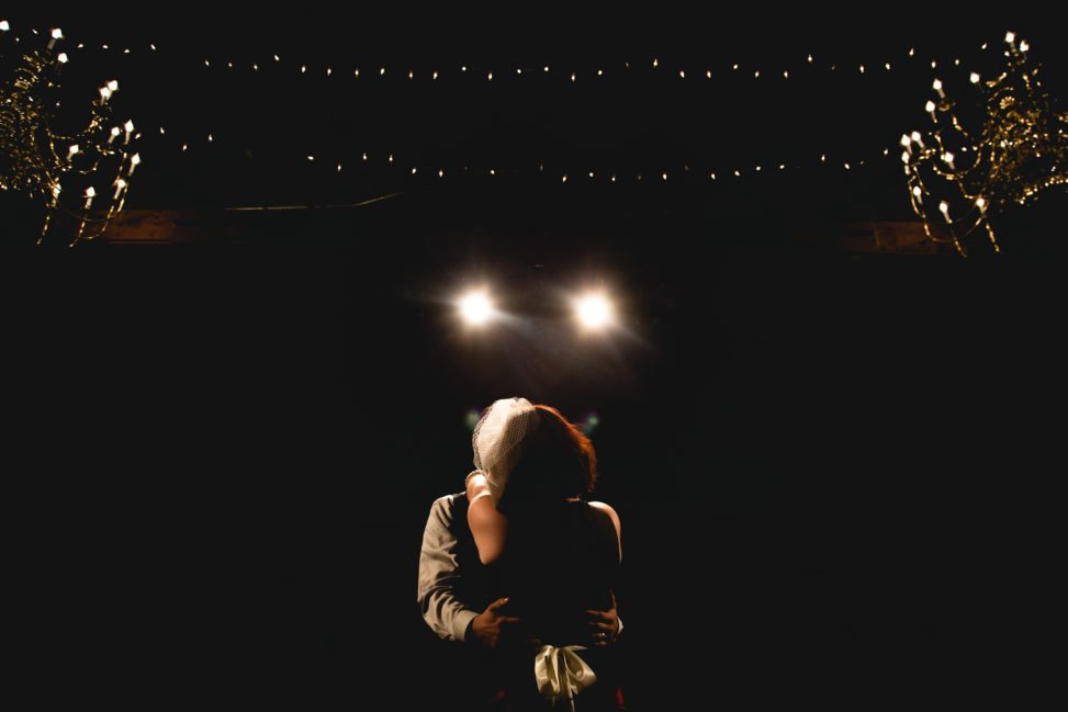 a wedding couple dance silently in the quiet darkness of their hearts