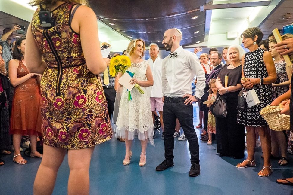 couple getting married in front of friends on a ferry boat