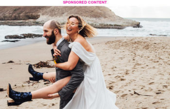 groom giving bride piggy back ride, both laughing, on a beach