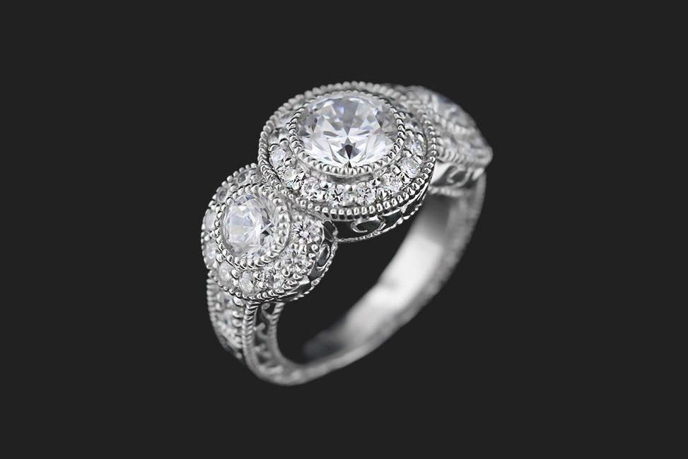 ethical three stone engagement ring with multi stone halo setting