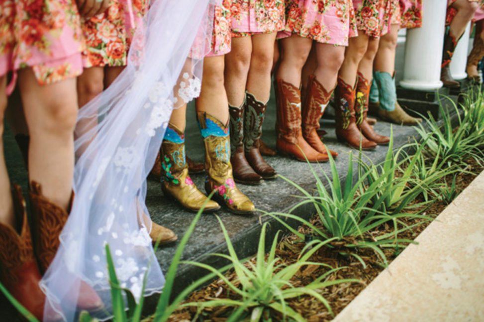 row of women in colorful cowboy boots