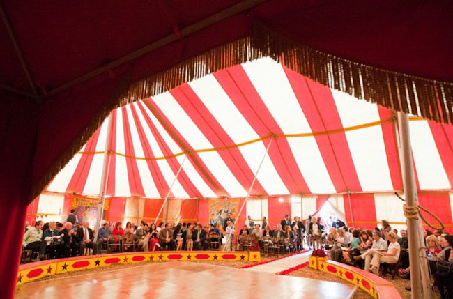 guests sit inside circus tent