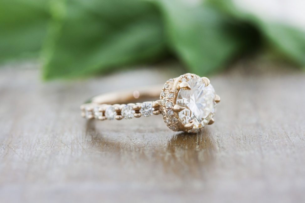 a beautiful engagement ring with diamonds on a wooden table