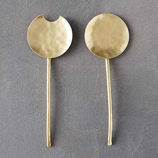 brass serving utensil pair on grey counter