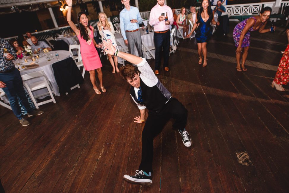 groom in chuck taylors breakdancing during reception