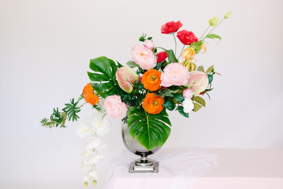 Fake flower arrangement that looks real with silk tropical leaves and silk peonies