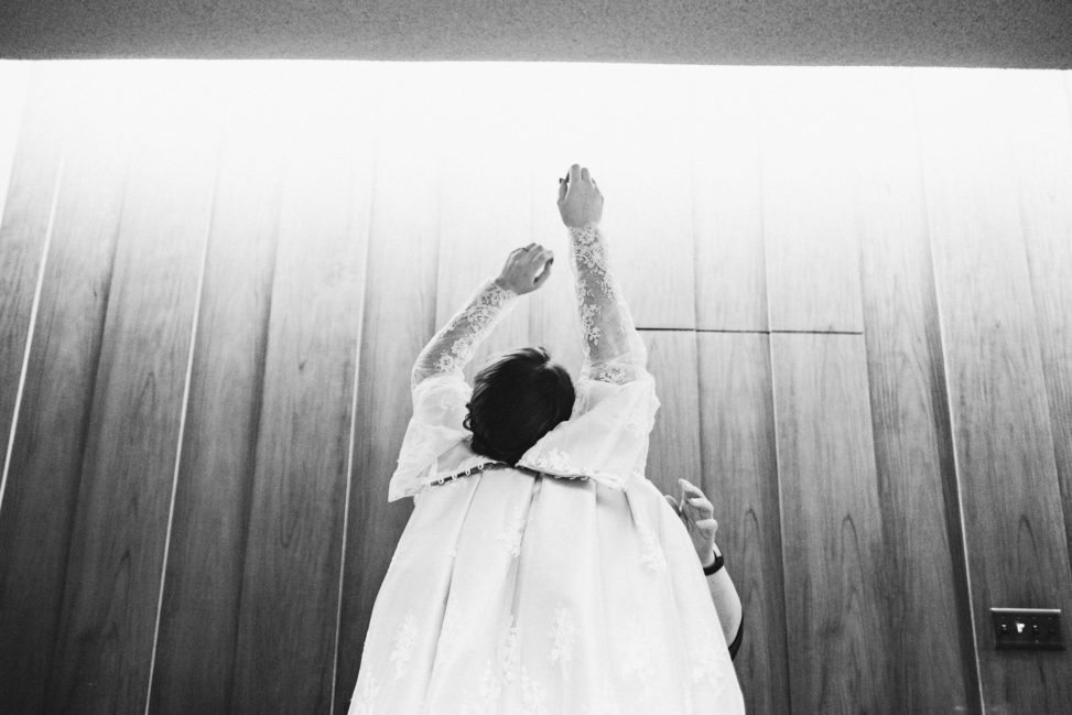 a woman puts on her wedding dress
