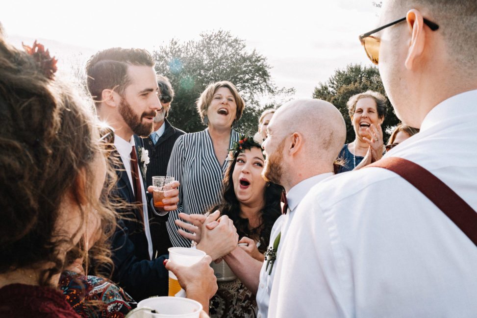 people making laughing O faces during a toast