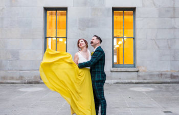 Bride in a yellow dress standing with a groom