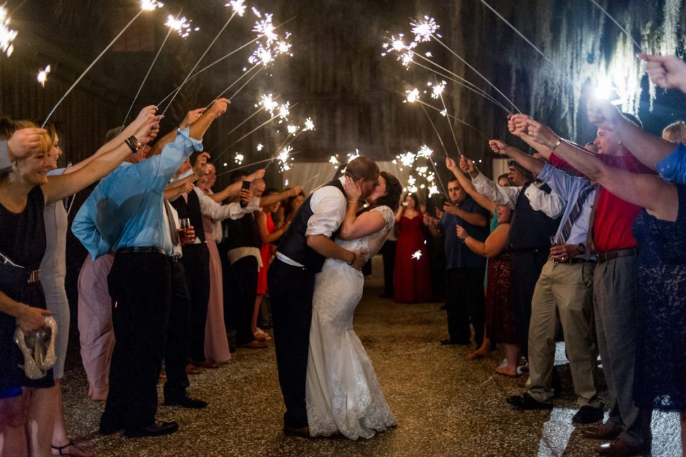 a man and woman kiss at the end of a sparkler exit