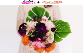 Woman in pink lace dress holding colorful bouquet with large tropical leaves