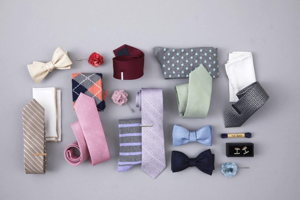 collection of ties and bow ties on a grey backdrop