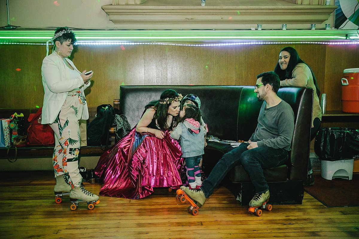 a family sits together after roller skating for 24 straight hours