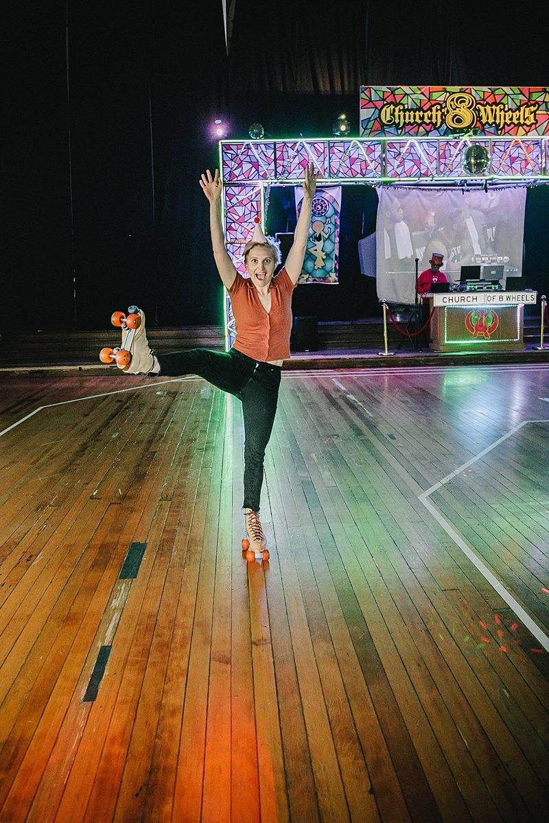 a woman roller skates with one leg in the air 