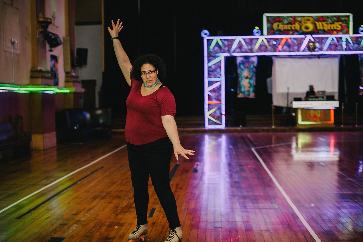 a woman poses on the roller rink floor