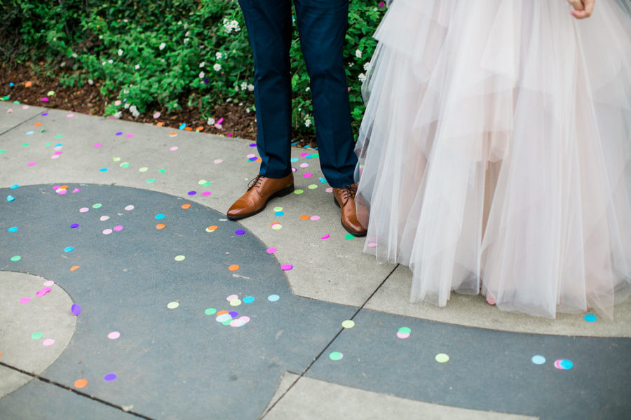 confetti at the feet of a bride and groom