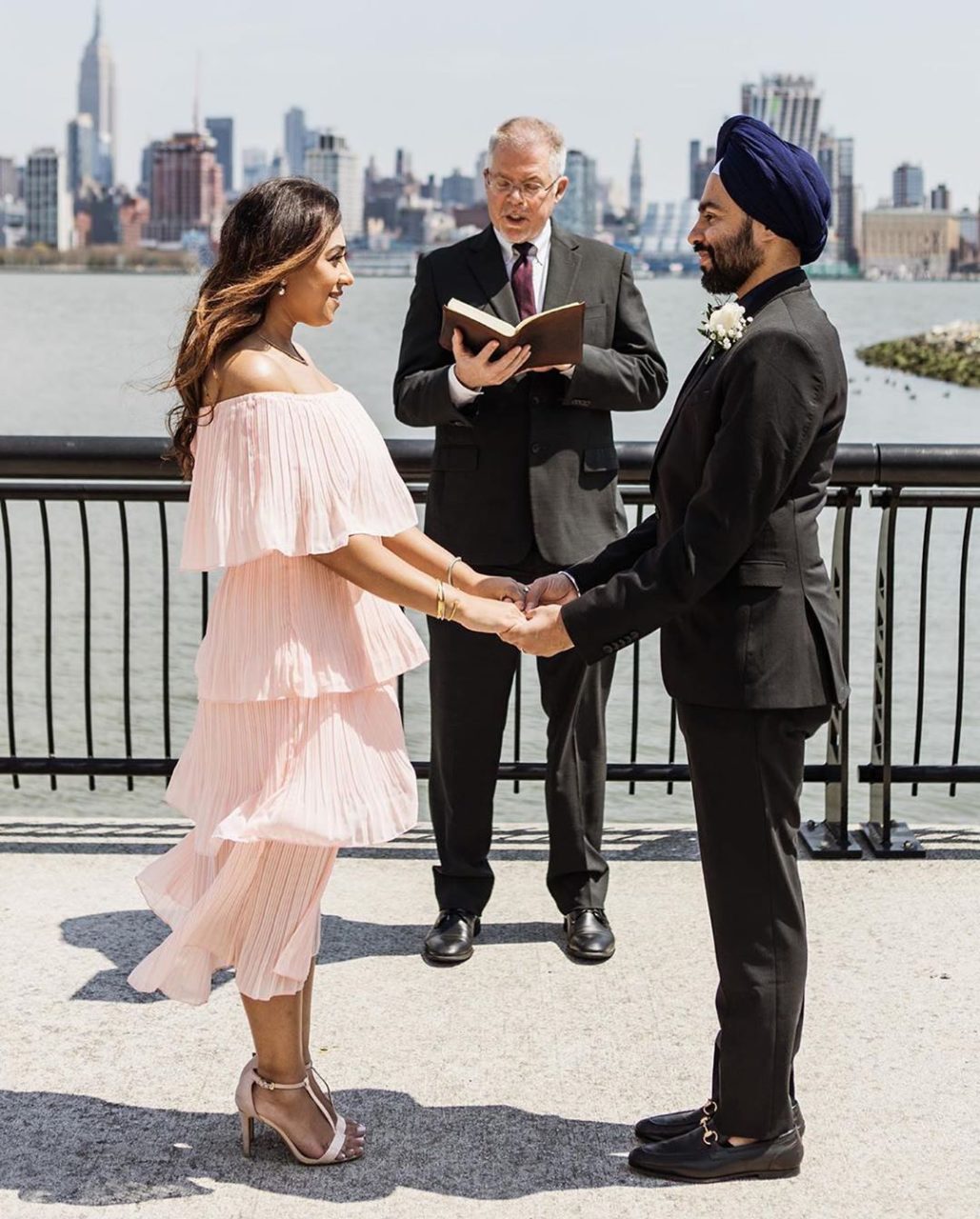 sikh couple getting married by the city skyline