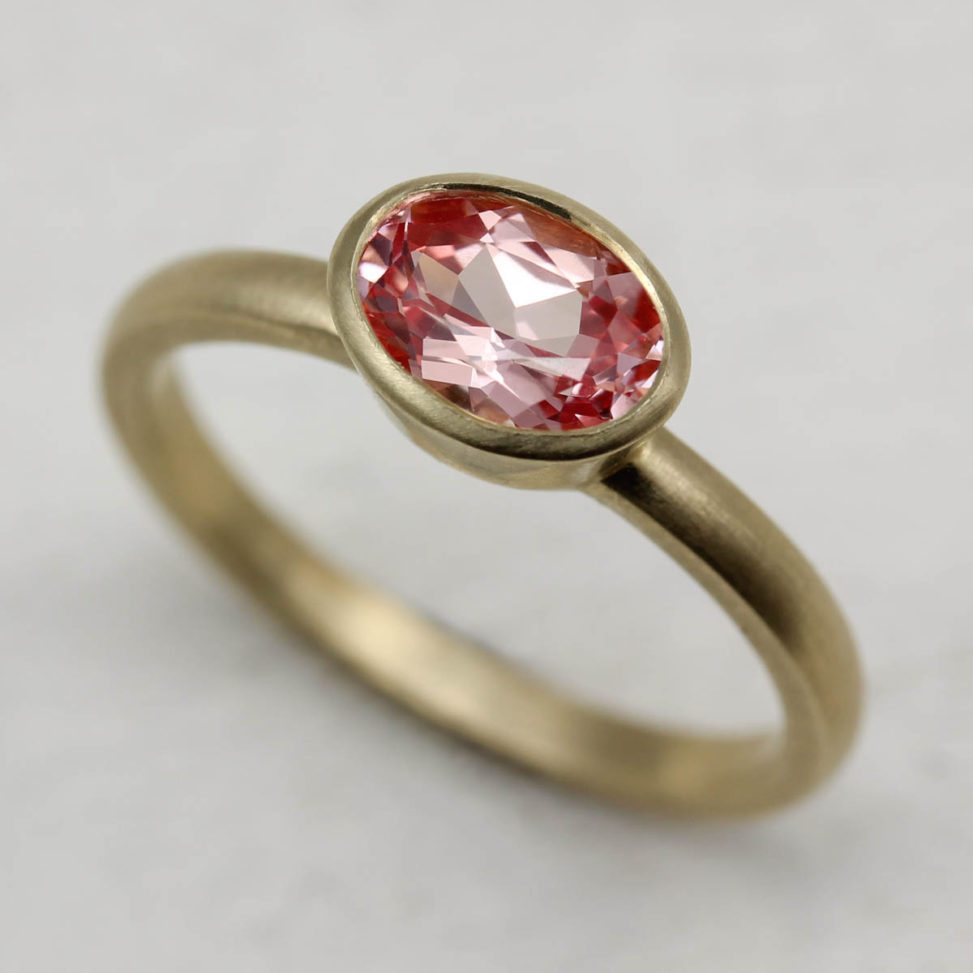 gold and pink gem ring on table