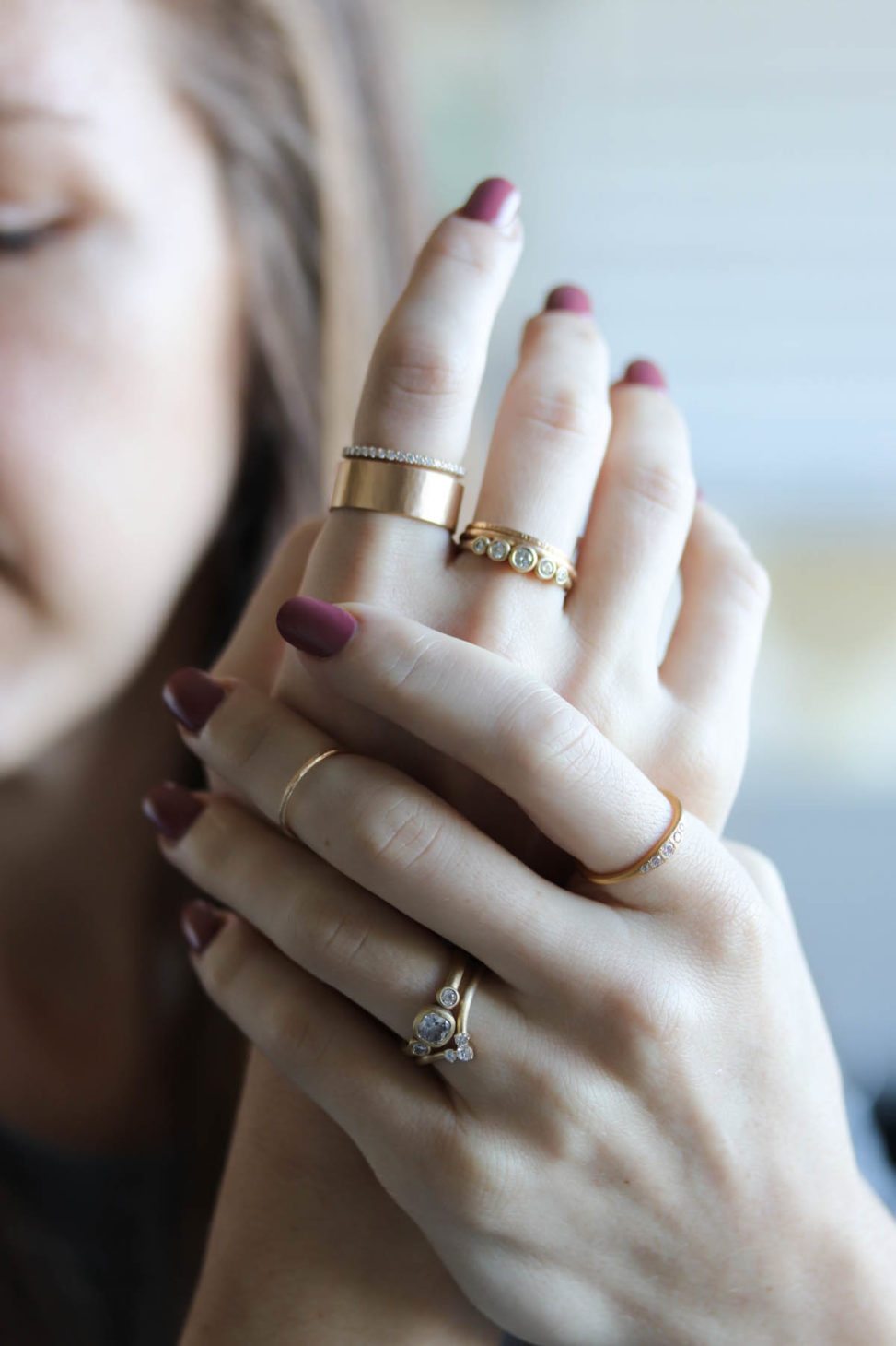 Woman holde her hands, wearing many rings