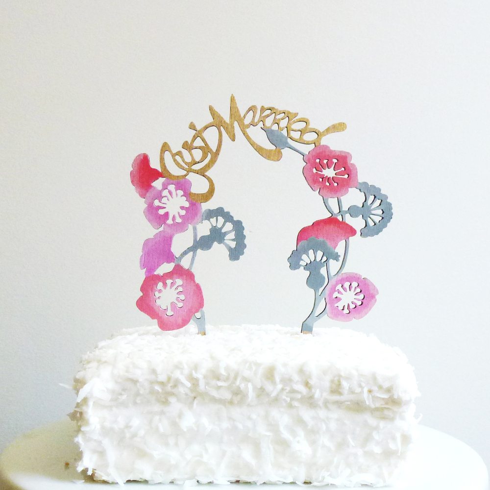 colorful wooden wedding arch cake topper that says just married