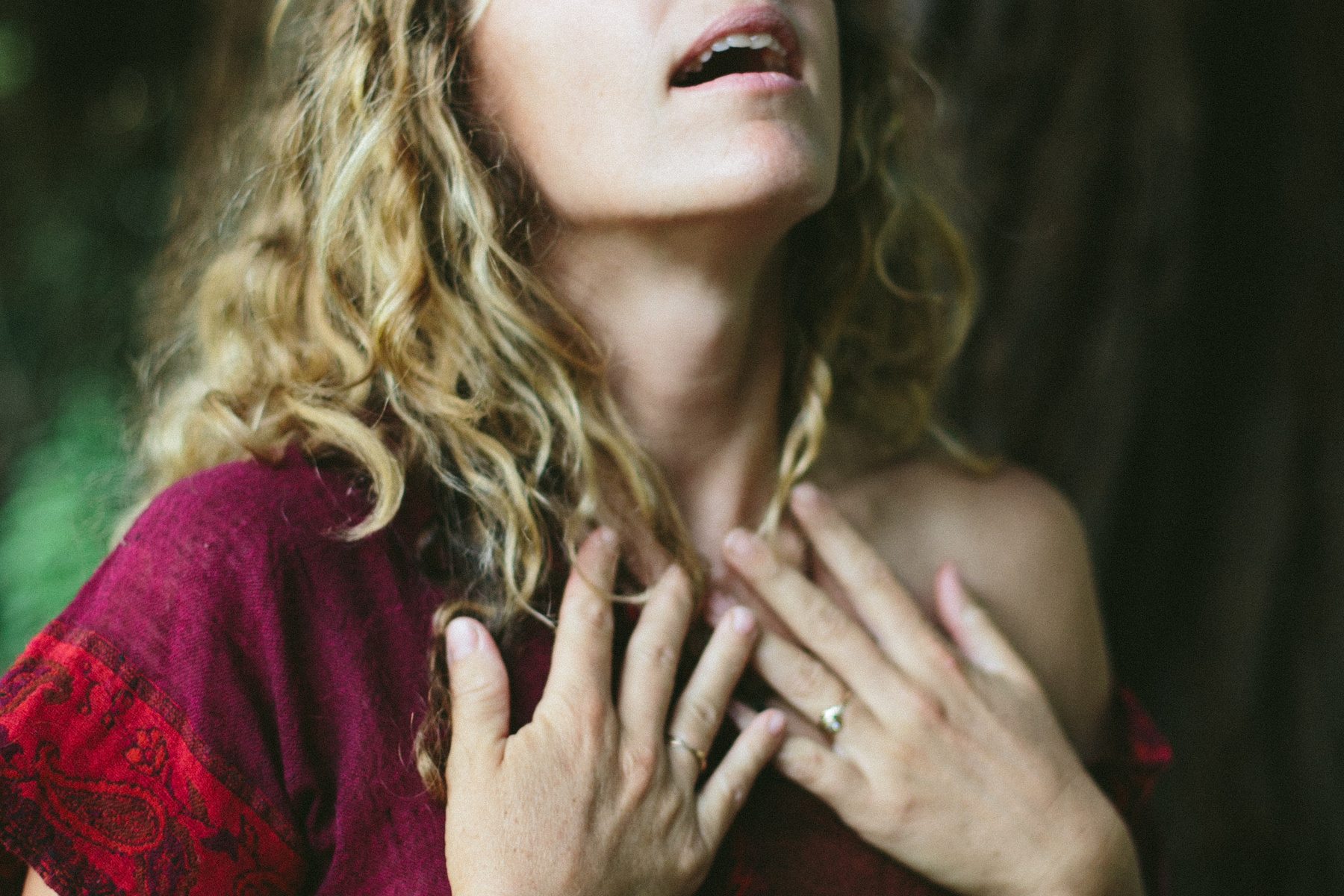 a woman with her hands on her chest, exhaling, and alive