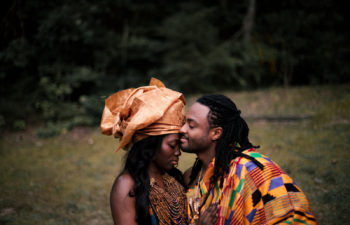 photo of man and woman in African clothing embracing