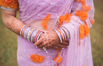 close up of a woman holding her hands against her body