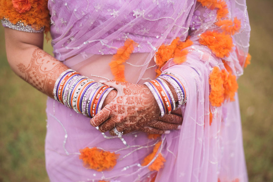 close up of a woman holding her hands against her body