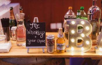 Close up of a bar with drinks and a sign that says "Mr. Whiskey"