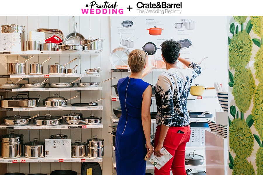 two women standing in front of a shelf of kitchenware at a crate and barrel LGBTQ wedding registry event