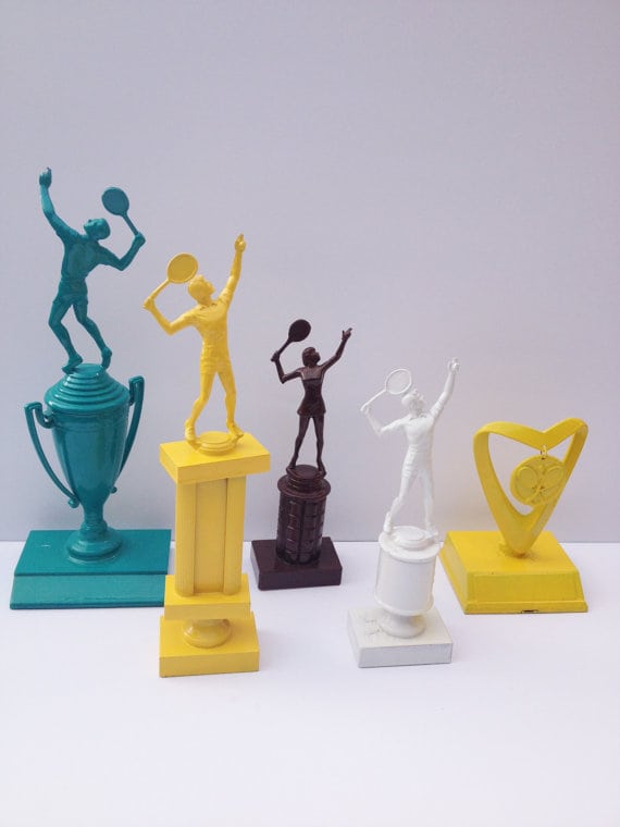 A group of sports trophies in various solid colors