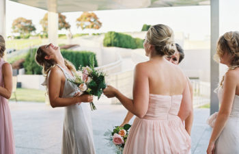 a bride throws her head back while laughing