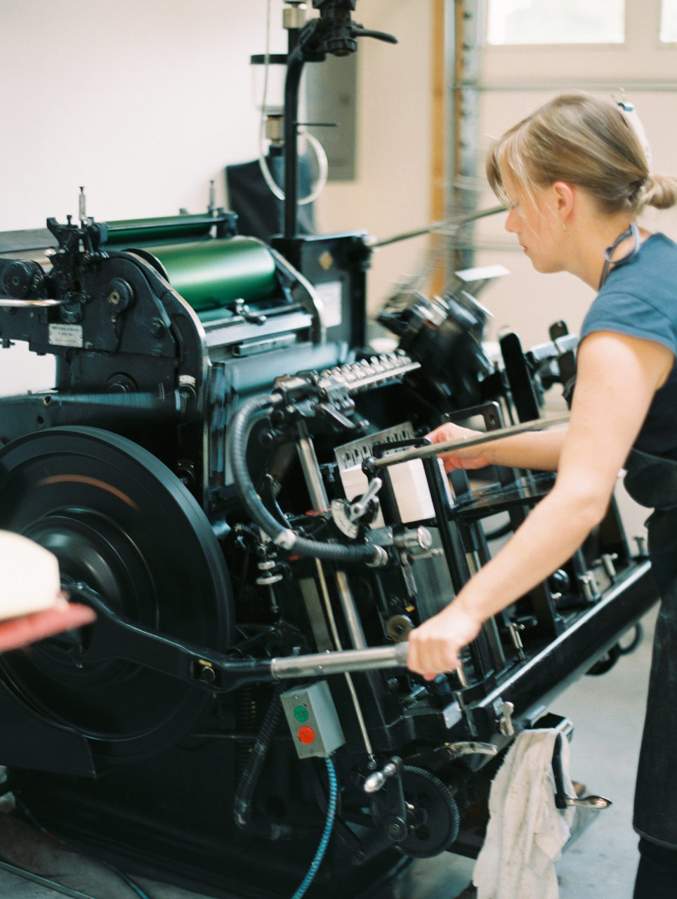 woman working letterpress machine