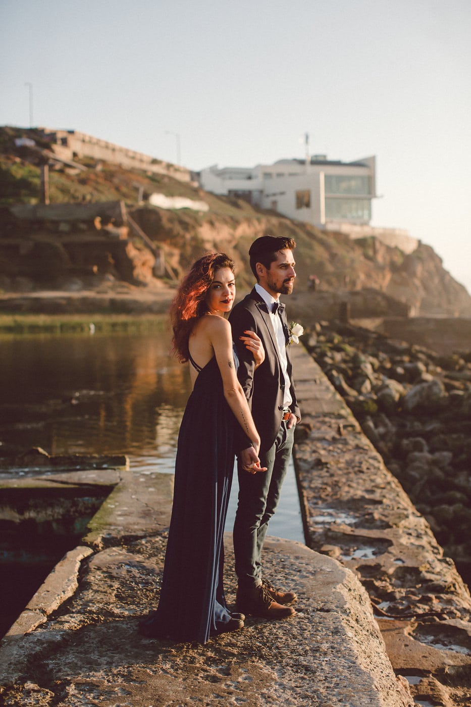 A couple with a black wedding dress on the beach