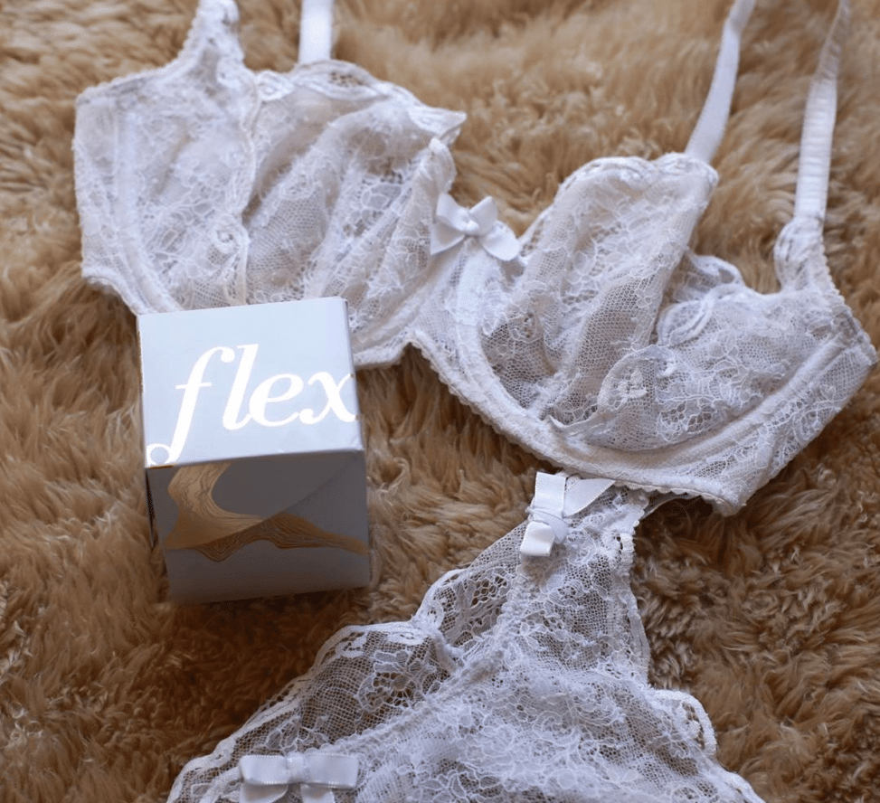 Bra and panty set next to a white box that reads "flex" in gold foil, on a shaggy fur blanket