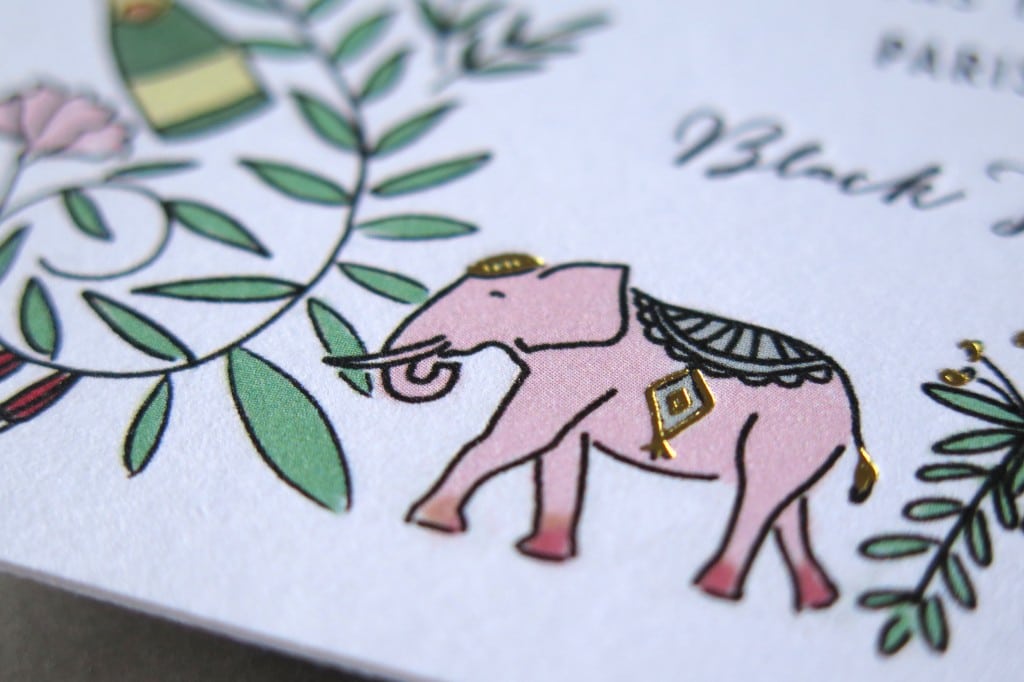 letterpress invitation detail: a pink elephant with gold foil