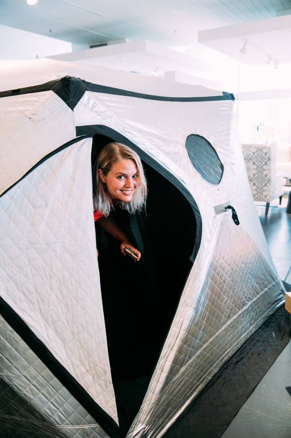A woman inside of the aura photography tent at the crate and barrel san francisco private registry event with a practical wedding