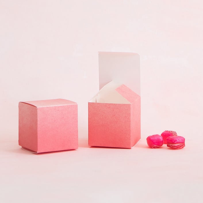 peachy-pink ombre favor boxes from minted alongside pink hard candies
