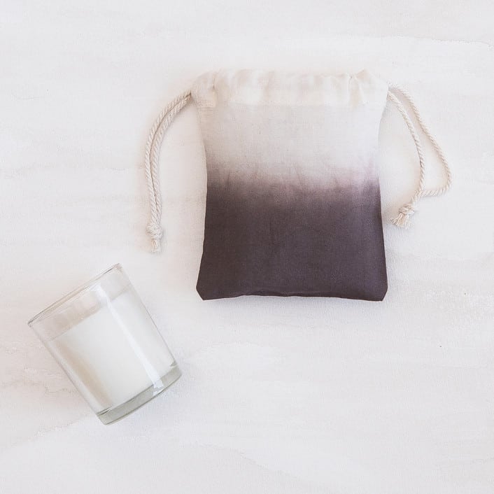 dark, warm gray dip-dyed drawstring pouch and candle from minted