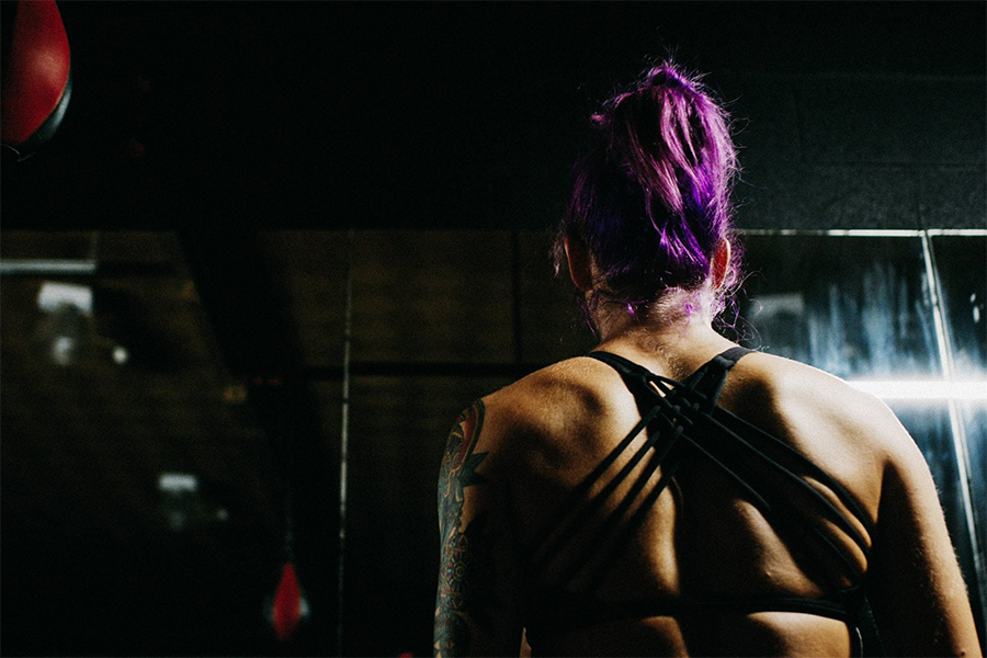 woman with purple ponytail in workout clothes