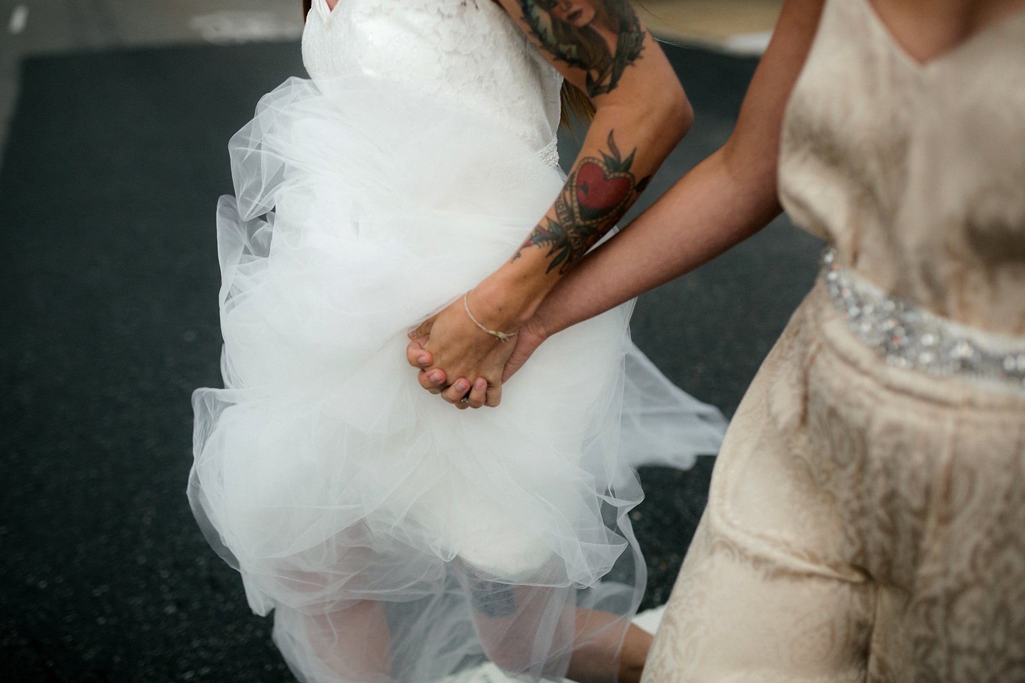 two brides hold hands, walking